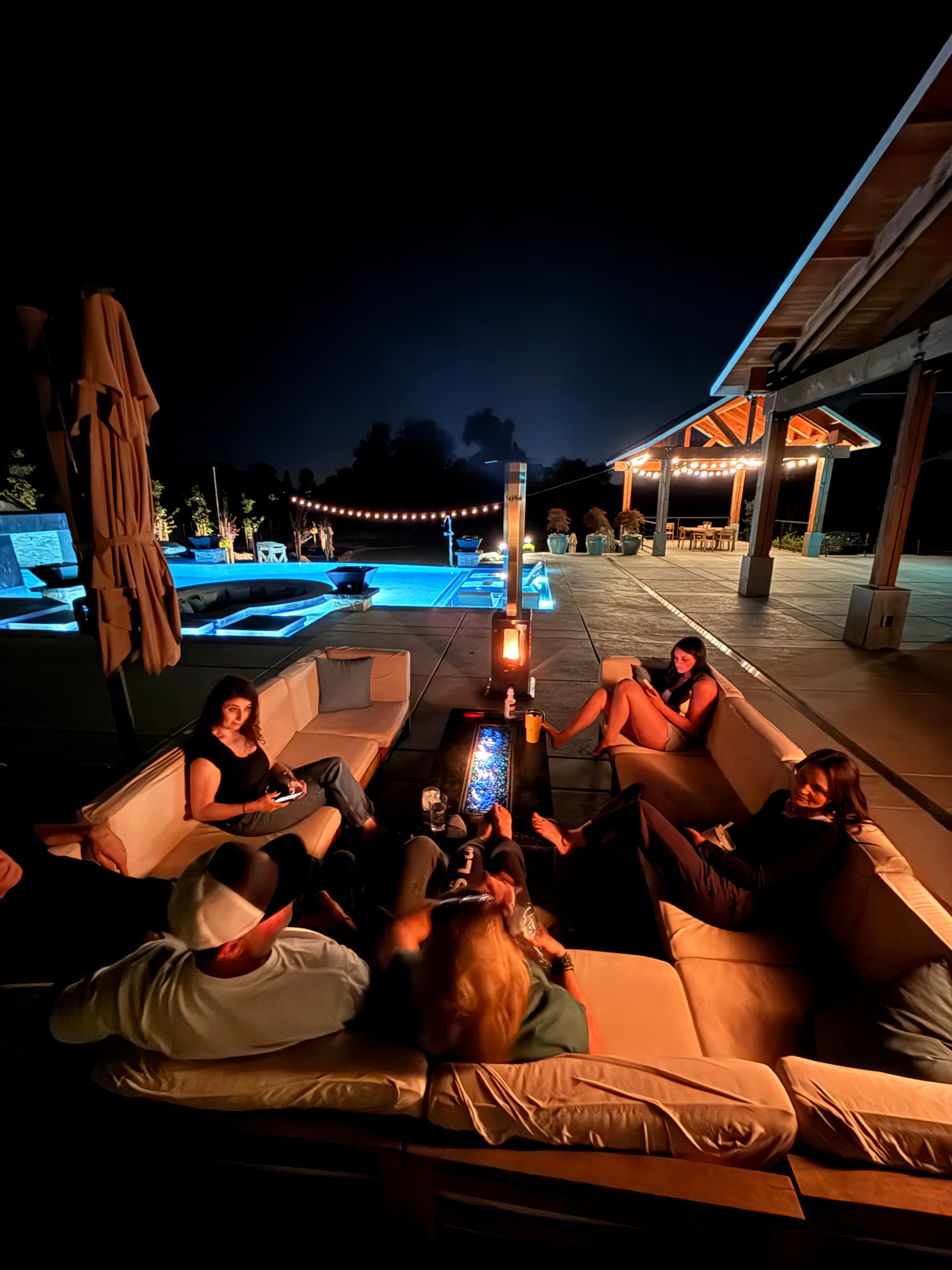 Sierra Stoves heater glowing poolside at night